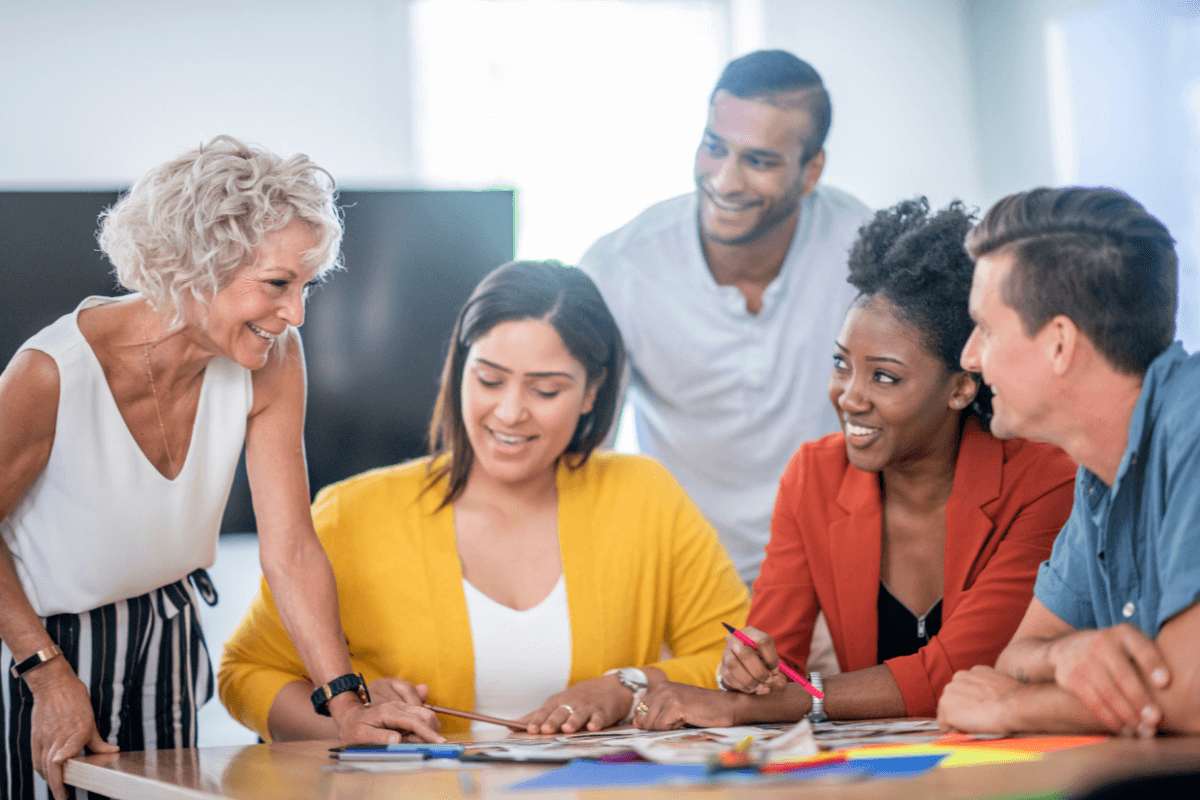 diverse group of office professionals sitting around a table