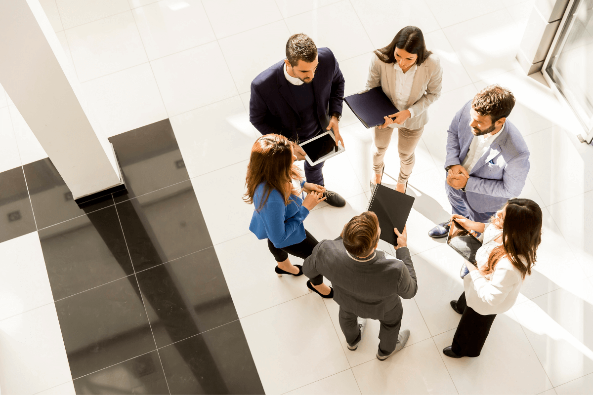 aerial view of group of workers standing in a circle