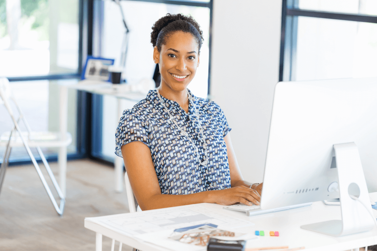 young African American woman sitting at a computer desk